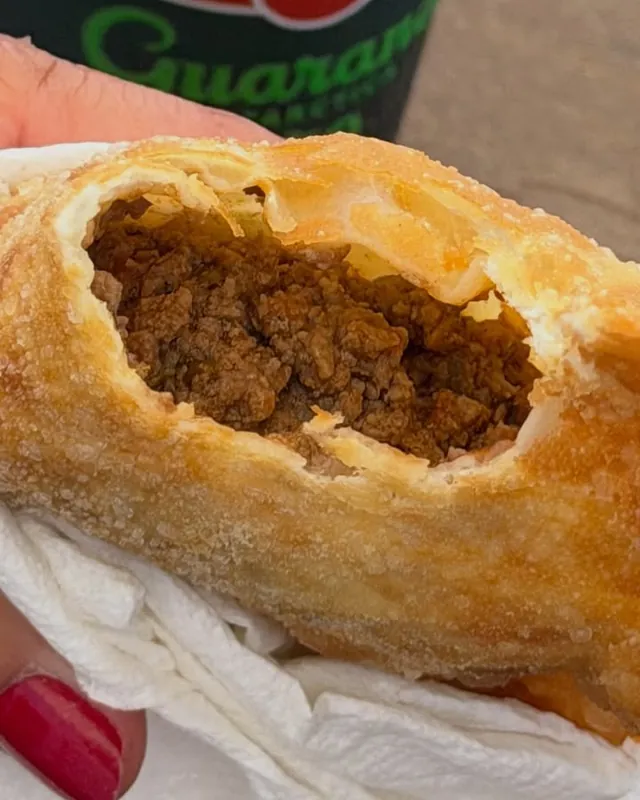 A ground beef pastel broken open